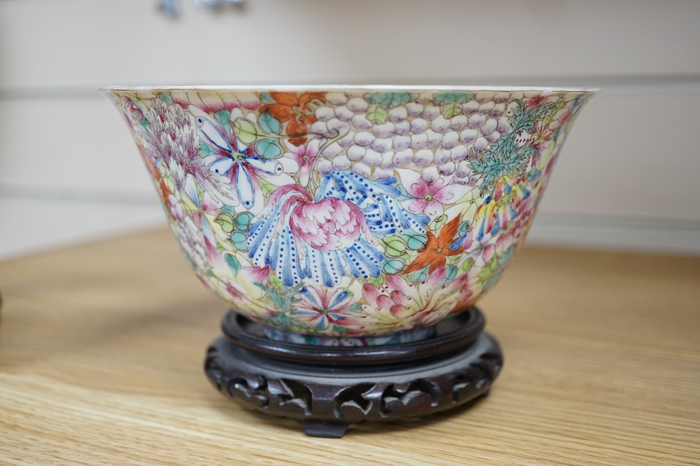 A Chinese 'Thousand Flower' enamelled porcelain bowl, Qianlong mark, early 20th century on hardwood stand, 17cm high